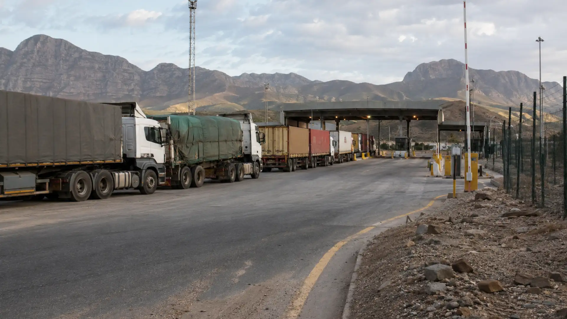 Xenophobia fleet logistics disruption — cross-border freight trucks at South African border post checkpoint
