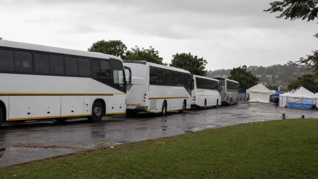 Fleet driver shortage repatriation — buses arriving to transport people from a Durban transit point