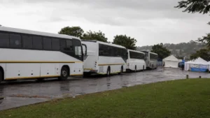 Fleet driver shortage repatriation — buses arriving to transport people from a Durban transit point