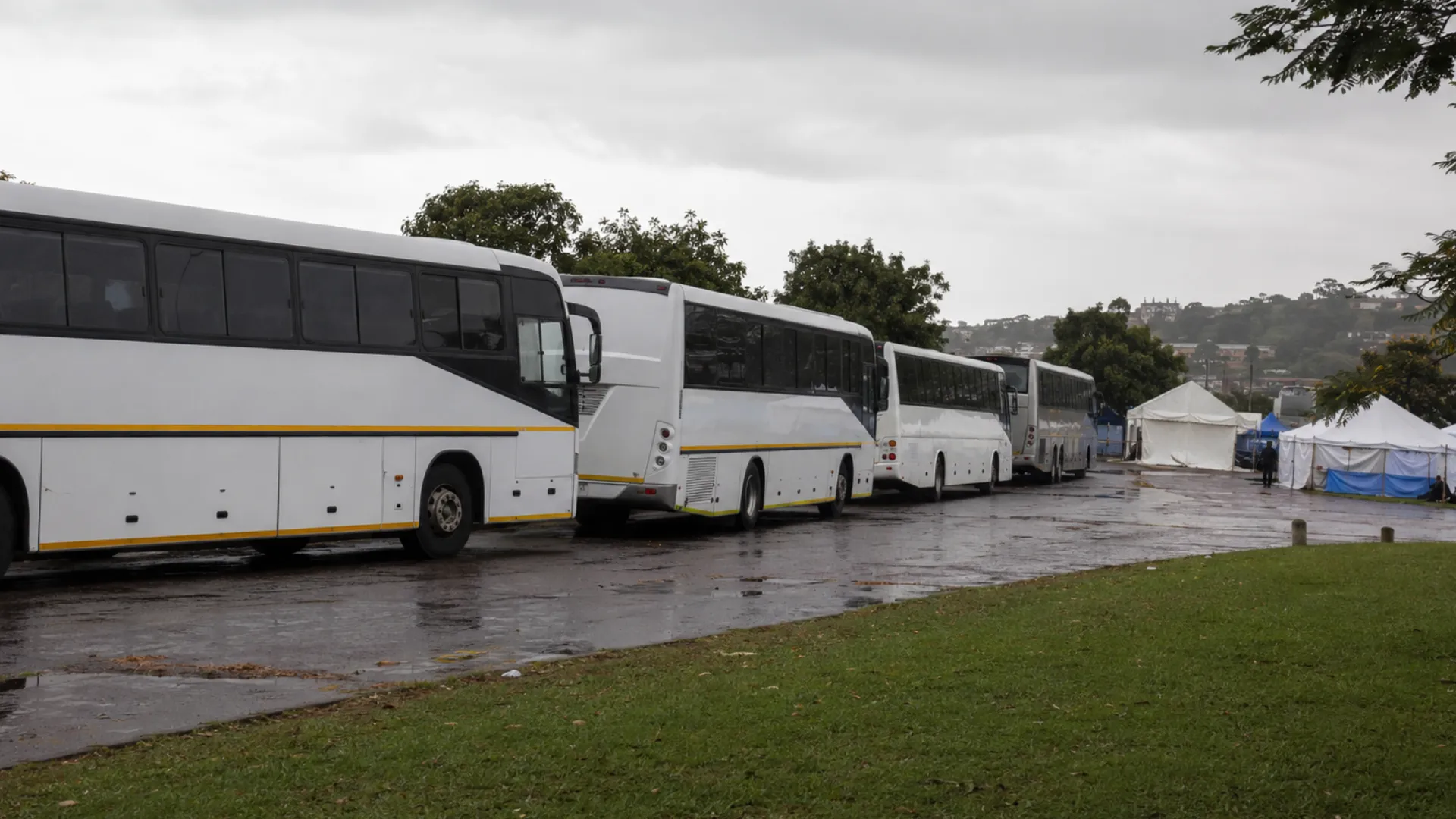Fleet driver shortage repatriation — buses arriving to transport people from a Durban transit point